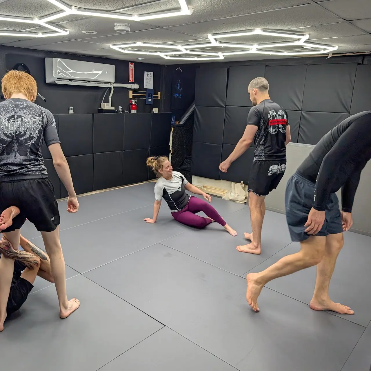 Students practising grappling at Code Black Jiu-Jitsu