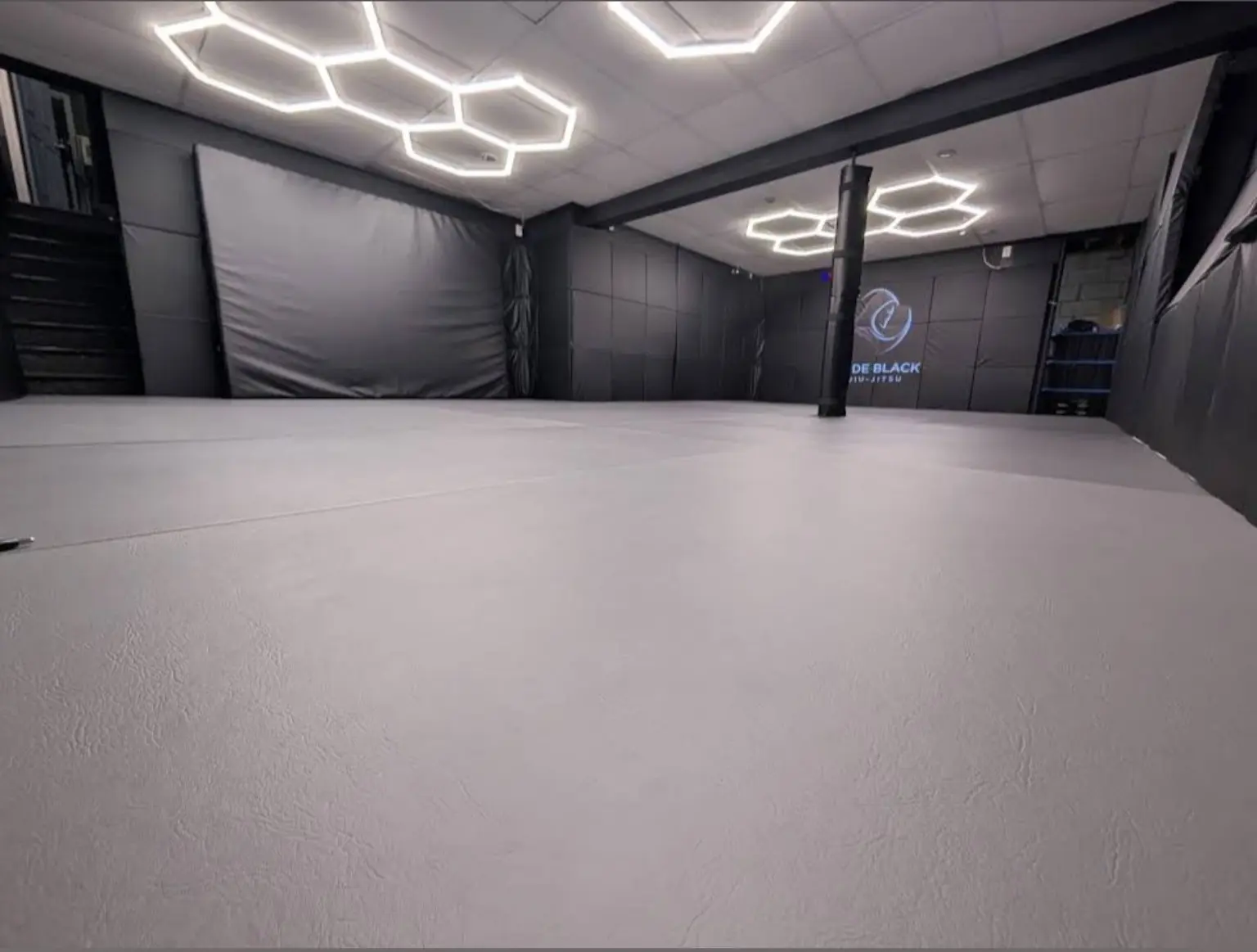 The clean matted training space inside Code Black Jiu-Jitsu