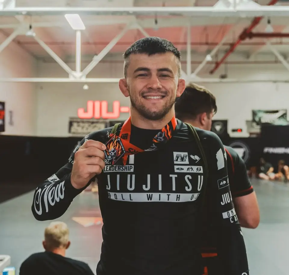 Head instructor Travis Szalay with a competition medal